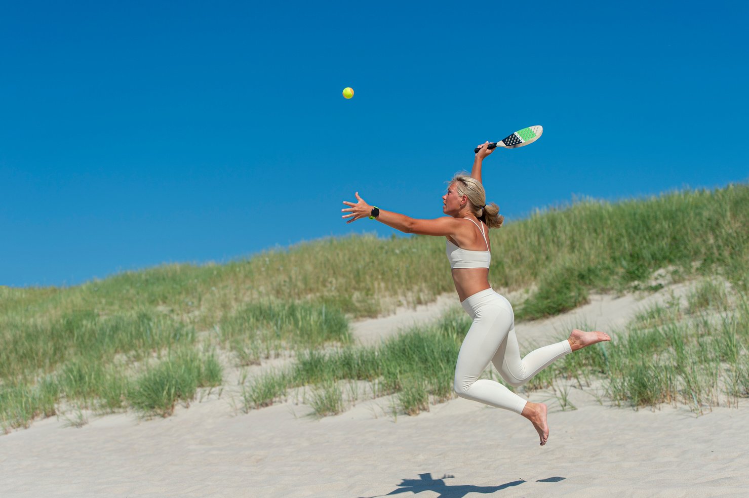 Woman Playing Beach Tennis